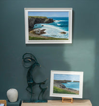 Load image into Gallery viewer, Framed artwork of a coastal scene on a wall with a sculpture and another smaller framed picture below.
