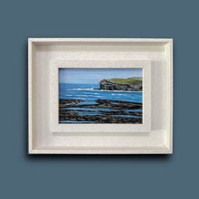 Load image into Gallery viewer, Framed artwork of a coastal scene with blue water and rocky shore on a solid background