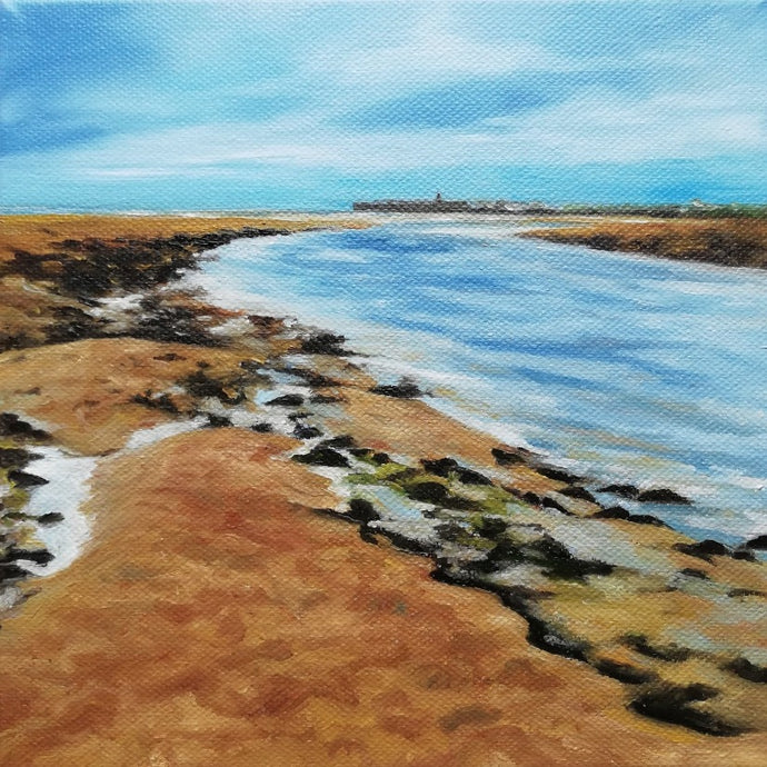 A framed oil on canvas painting depicting a coastal scene with a body of water, sandy beach, and rocky shoreline, predominantly in blue and brown tones.